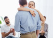 man and woman embrace during group addiction treatment therapy in florida