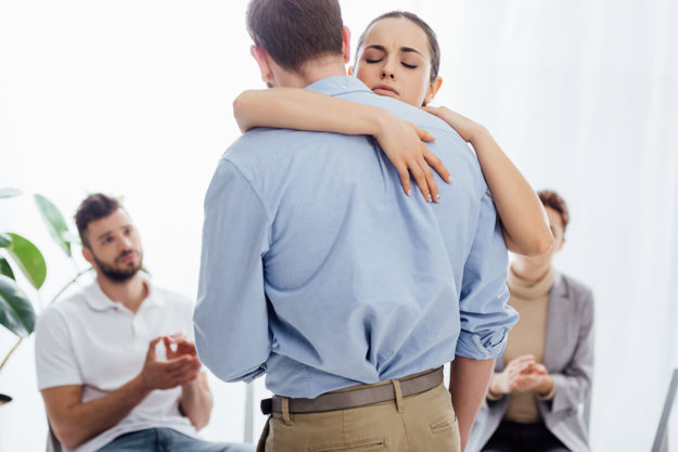 addiction treatment therapy in florida man and woman embrace during group addiction treatment therapy in florida